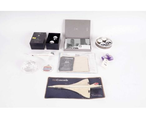 A collection of British Airways Concorde memorabilia, including: a Stuart Crystal Concorde paperweight; a Concorde model airp