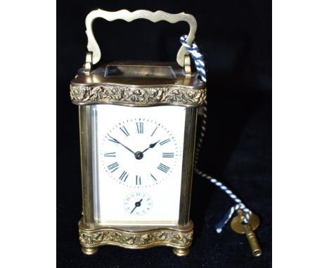 A BRASS CASED CARRIAGE CLOCK WITH ALARM  in Doucine case, the enamel dial with Roman numerals and subsidiary alarm dial, 13cm
