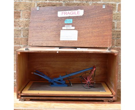 A MUSEUM MODEL OF A 'TURNWREST' OX-PLOUGH  made by Philip Veale of Barcombe, Sussex, set to a wood base, the whole 64.5cm lon