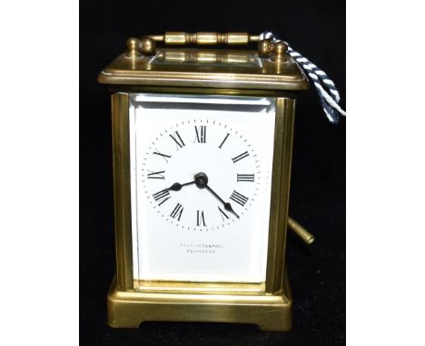A BRASS CASED CARRIAGE CLOCK  the enamel dial with Roman numerals, signed 'PAGE, KEEN &amp; PAGE, PENZANCE', 12cm high with c