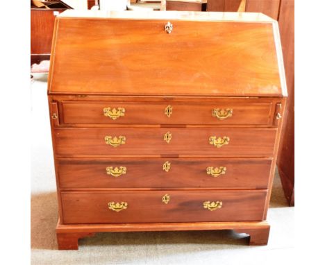 MAHOGANY FALL FRONT BUREAU  opening to reveal a fitted interior with eight pigeon holes above a central drawer flanked to eac
