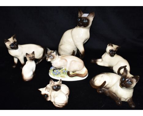 A COLLECTION OF ASSORTED SIAMESE CAT ORNAMENTS  including Beswick, Doulton and Royal Adderley examples, the largest a Beswick