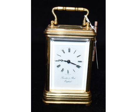 A BRASS CASED CARRIAGE CLOCK  the enamel dial and movement both signed 'Thwaites &amp; Reed', 13.5cm high with carrying handl