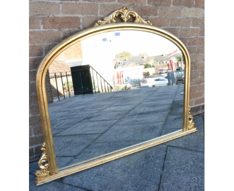 A GILT OVERMANTEL MIRROR the plate measures H 86cm x W 109cm, overall H 106cm x W 137cm