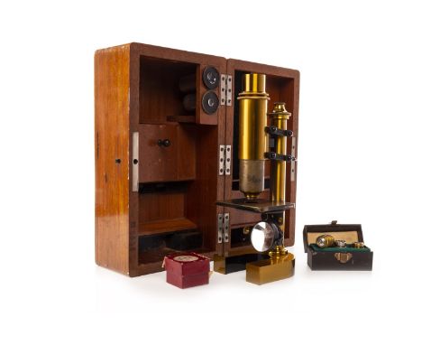REICHERT BRASS MONOCULAR MICROSCOPE, with dual struts, two lenses no. 1 and 2 and a box of three objective lenses, the 'U' sh