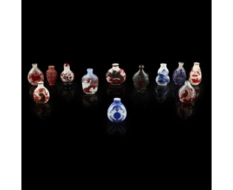 COLLECTION OF TWELVE SNUFF BOTTLES19TH/20TH CENTURY comprising: a red-overlay clear glass bottle, decorated with the 'Auspici