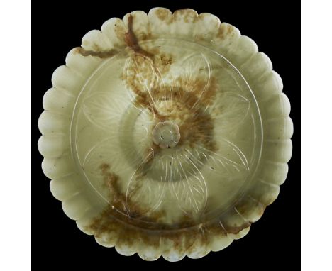 MUGHAL-STYLE GREEN JADE PLAQUE19TH CENTURY carved in the shape of a chrysanthemum blossom, the interior inset with a yellow m
