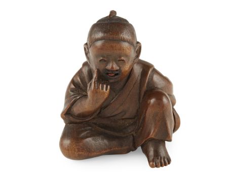 BOXWOOD KARAKURI NETSUKE OF A SEATED BOYSIGNED SEIMIN, MEIJI PERIOD the boy depicted seated and supporting his chin on his ra