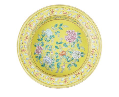 FAMILLE ROSE YELLOW-GROUND BASIN20TH CENTURY painted in vibrant famille rose tones with peony branches surrounded by further 
