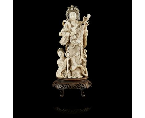 FINELY CARVED IVORY OKIMONO OF BENZAITEN PLAYING A BIWAMEIJI PERIODshown standing, holding the musical instrument in her left