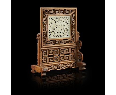 CELADON JADE PLAQUE MOUNTED AS A TABLE SCREENLATE QING DYNASTY the jade plaque delicately carved and pierced with a stylised 