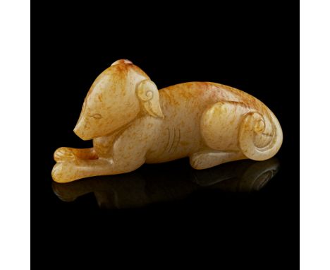 CARVED YELLOW JADE MODEL OF A HOUNDnaturalistically carved as a recumbent hound with its head above his outstretched paws, hi