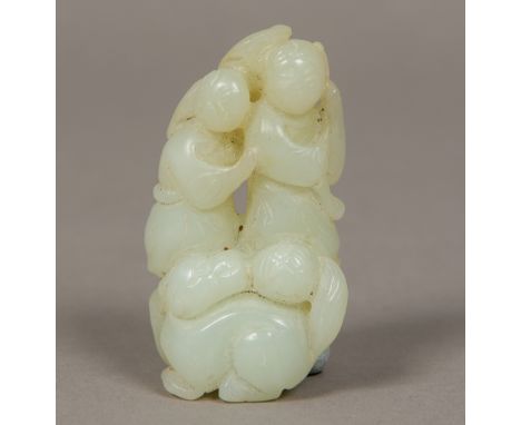 A Chinese carved mutton fat jade group 
Worked as a temple lion before a pair of figures.  7.5 cm high.  CONDITION REPORTS: G