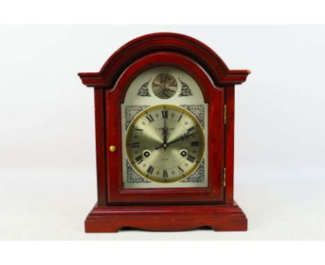 A contemporary 31 day Tempus Fugit mantel clock signed C Wood & Son to the arched dial, 36 cm (h), with key. [W]