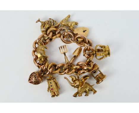 A 9ct yellow gold charm bracelet with padlock clasp, safety chain and 9 yellow gold charms, all 9ct, to include crown, Dumbo,