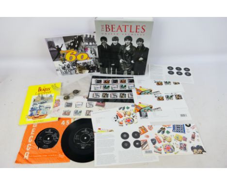 The Beatles - A collection of Beatles related items to include publications, two 7" vinyl singles, first day covers and mint 