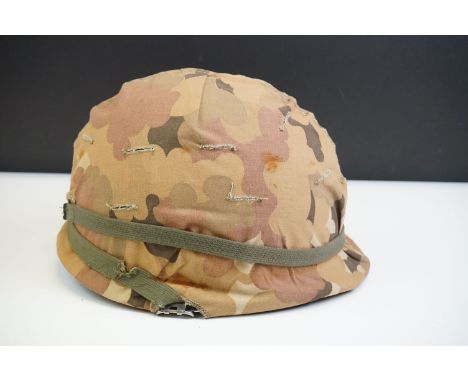 A British Military Helmet Complete With Liner And Desert Camouflage Cover. 