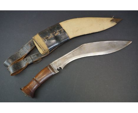 A British World War Two Era Kukri Knife Complete With Scabbard, Wooden Handle Marked With The British Broad Arrow. 