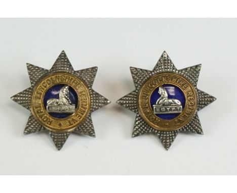 A Pair Of British Military The Royal Lincolnshire Regiment White Metal Collar Badges Of Two Piece Construction With Blue Enam