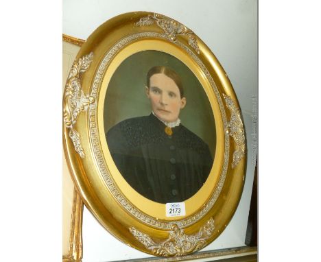 An oval frame and mounted Painting depicting a portrait of a Lady in a black dress