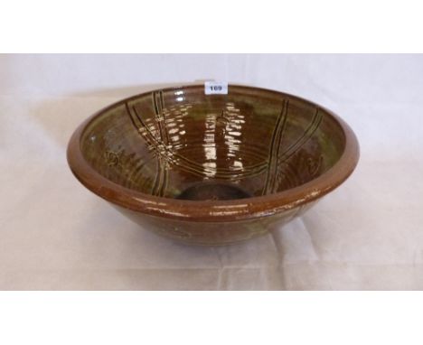 Michael Cardew. Winchcombe Pottery. An earthenware bowl with geometric line decoration on a lustrous brown green glaze. Impre