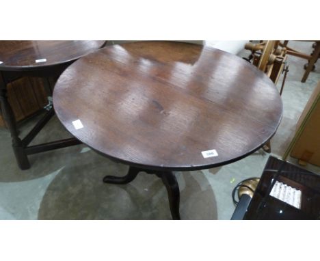 A 19th century oak snap-top tripod table. 31'' diameter