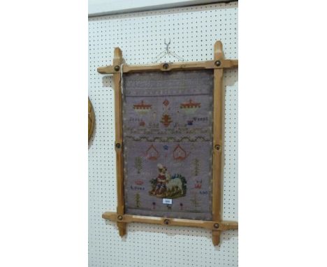 A Victorian tapestry sampler worked by Lydia Jones, with alphanumeric sequences, religious verse, boy with a lamb and typical
