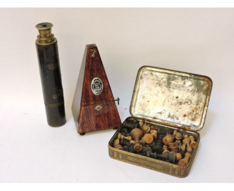 A 19th century brass and leather bound telescope, a metronome, and chess set
