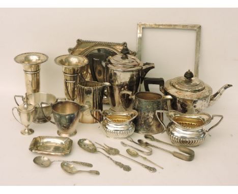 A collection of silver items, a pair of vases, picture frame, urn and cover, sugar nips, caddy spoon, and silver plate