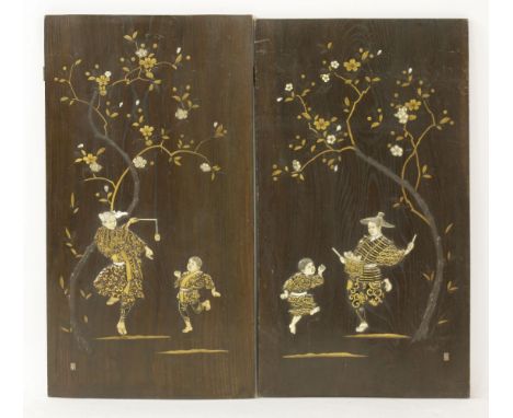 A pair of paulownia wood panels, Meiji period, onlaid with carved wood, bone, ivory and mother-of-pearl entertainers, each be