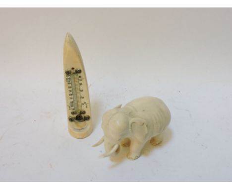 A 19th century carved ivory elephant, 7.5cm high and an ivory thermometer, incomplete, 15cm