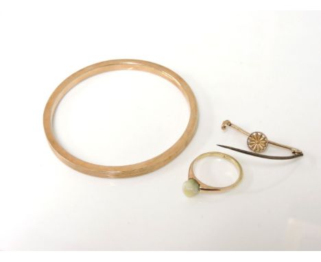 A 9ct gold hollow bangle, a gold blister pearl ring, and a gold detachable brooch fitting