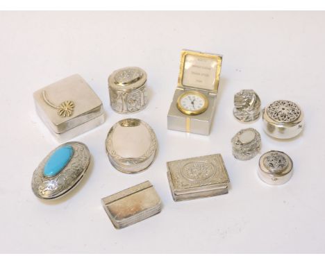 Nine assorted modern silver pill boxes, a silver thimble, and a plated clock