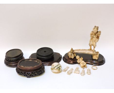 A late 19th century Japanese walrus ivory group,  of a man pounding a drum to amuse a child on a bench, 16cm, five Chinese iv