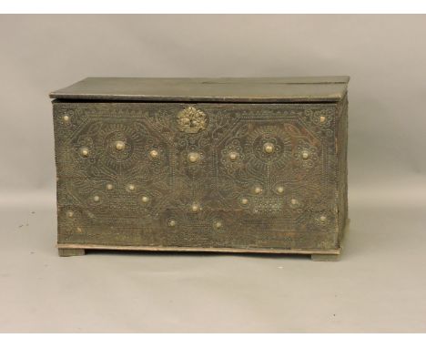 An early studded leather trunk, now with wooden lid. 105cm wide