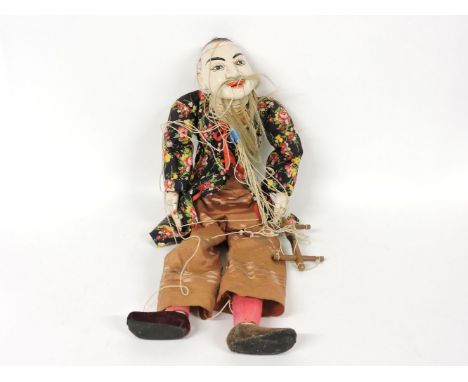 A Chinese wood puppet, as an old man