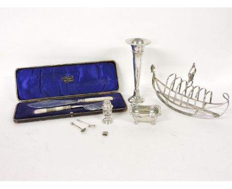 A silver plated toast rack in the form of a boat, together with a silver bud vase, a pair of silver and mother of pearl fish 