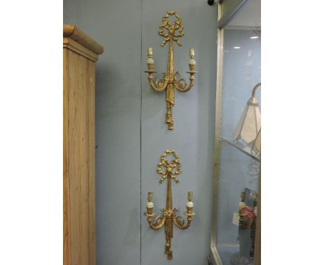 Six pairs of gilt metal ormolu wall lights, each with two scrolling branches and ribbon bow finial