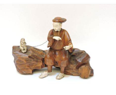 A  late 19th century Japanese wood and ivory sarumawashi, the man with boxwood body pointing at his drum, 25.5cm