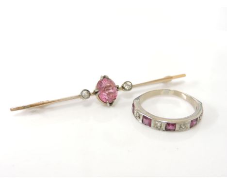 A gold oval cut pink tourmaline and diamond bar brooch, together with a gold ruby and diamond half eternity ring, tested as 1