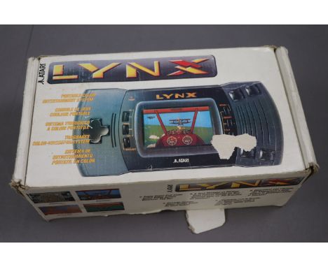 Boxed Atari Lynx hand held console with 3 x games to include Chips Challenge, Gates of Zendocon and Turbo Sub