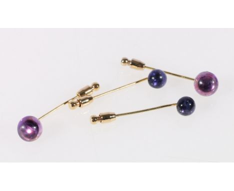 Four amethyst set stick pins