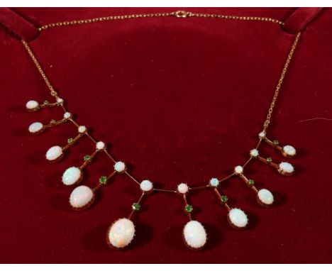 Edwardian fringe necklace with eleven oval opals, each upon a knife edge with a demantoid garnet dependant from a smaller opa