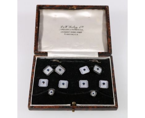 Set of Art Deco studs, links and buttons with a sapphire collet, upon mother of pearl white gold '9ct', Sorley, Glasgow case.