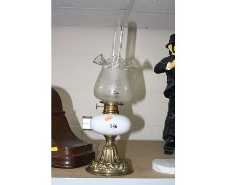 A SMALL BRASS OIL LAMP, with etched shade and clear glass funnel