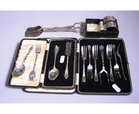 A CASED SILVER CHRISTENING SPOON AND FORK, two engine turned cased silver napkin rings monogrammed 'E', together with plated 