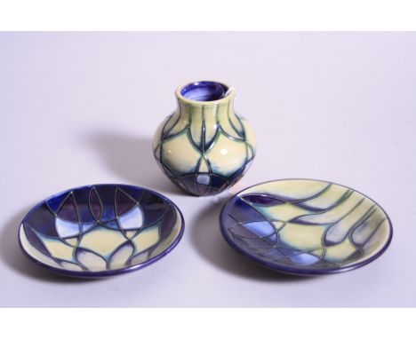 THREE PIECES OF MOORCROFT POTTERY, Indigo design, to include small vase and two trinket dishes, impressed and painted marks t