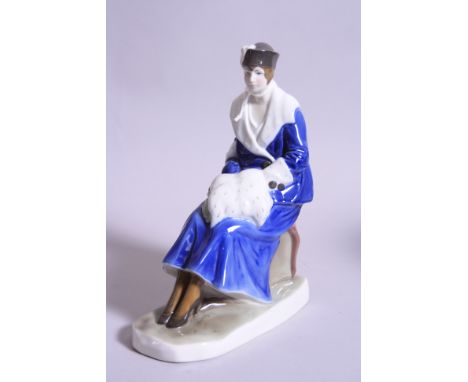 A FRAUREUTH KNUSTABTEILUNG FIGURINE, seated lady in fur trim coat and muff, factory backstamp
