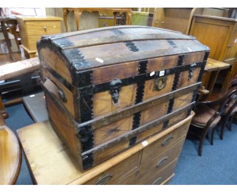 A DOMED TOPPED TRUNK, with metal banding and embossed leather detail (sd)