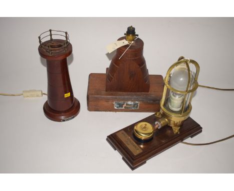 A table lamp made form teak taken from HMS Trincomalee; a lighthouse pattern table lamp of timber from the HMS Cornwall; and 